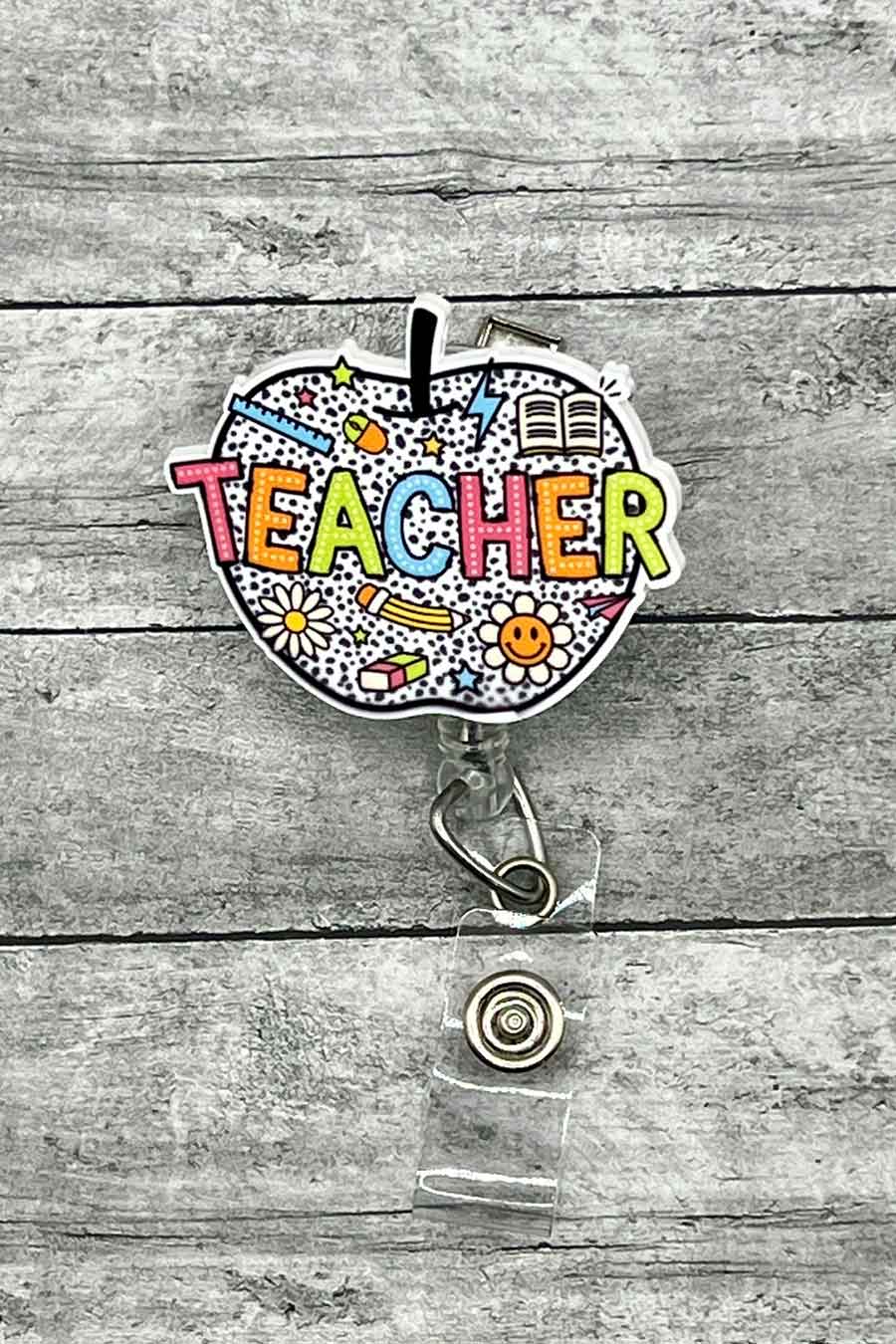 Apple Doodle Teacher Badge Reel featuring a colorful apple design with doodles and the word 'TEACHER' in vibrant letters