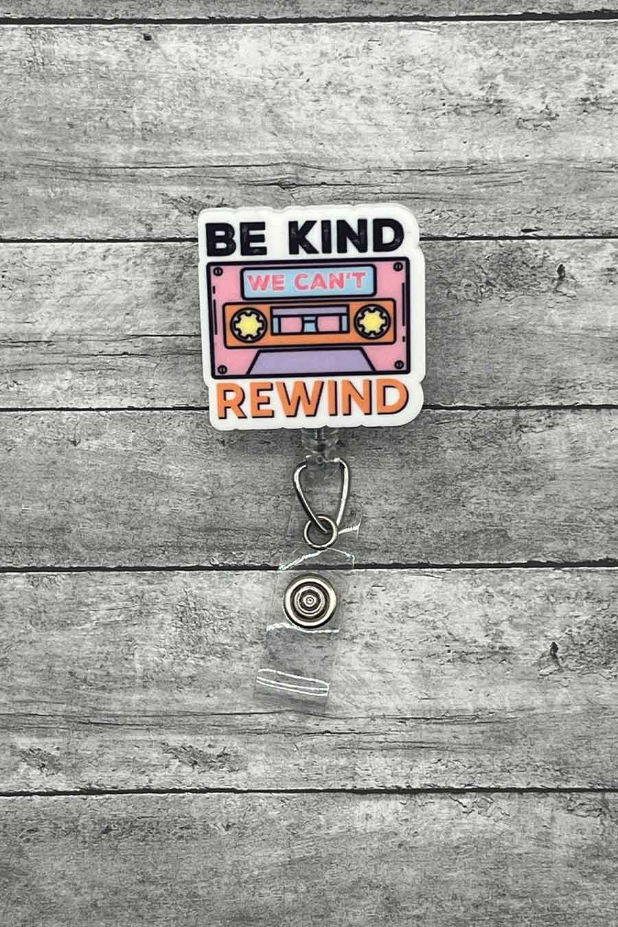 "Be Kind Rewind Badge Reel featuring a retro cassette tape design with the phrase 'Be Kind, We Can't Rewind'.