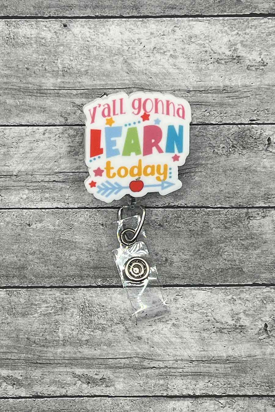 "Learn Today Badge Reel featuring the phrase 'Y'all Gonna Learn Today' in bright, colorful letters, laying on a gray wood background."